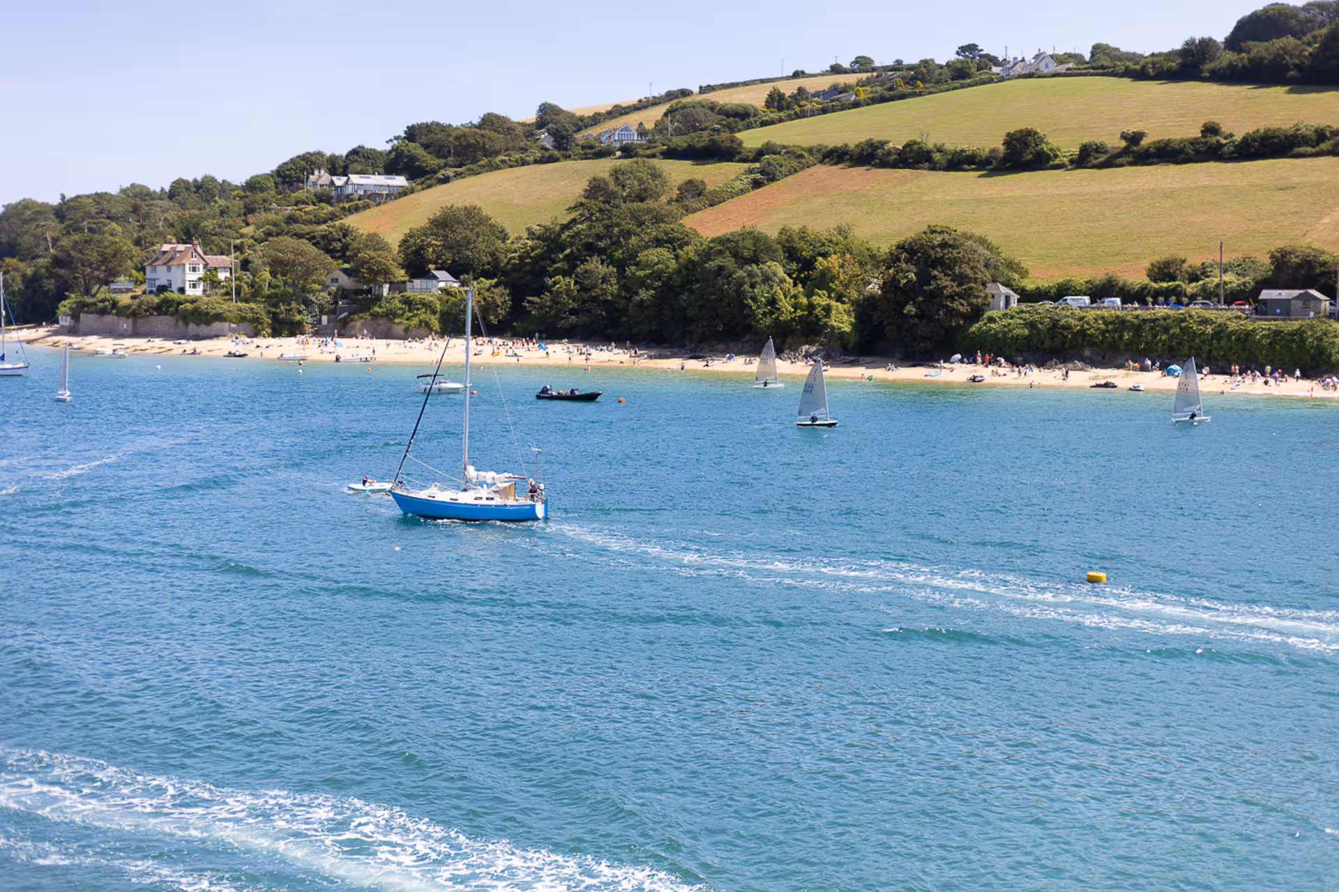 Sailing boats on a calm river estuary in Devon